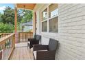 Close-up of a charming front porch with chairs, featuring a light brick wall and wood accents at 1266 Elizabeth Sw Ave, Atlanta, GA 30310