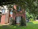 Residential home with brick facade, surrounded by a green lawn and mature trees at 455 Crafton Ct, Lawrenceville, GA 30043