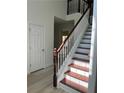 Bright entryway featuring a staircase with wooden handrail and white risers at 455 Crafton Ct, Lawrenceville, GA 30043