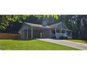 Single-story home with covered parking, front porch, and attractive landscaping at 2357 Whitehouse Rd, Dacula, GA 30019