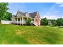 Spacious home featuring a cozy porch, well-maintained lawn, and classic architectural design, ideal for Gathering living at 71 Barrington Dr, Hiram, GA 30141