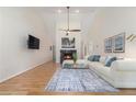 Bright living room with hardwood floors, a fireplace, a ceiling fan, and comfortable seating area at 1402 Mclendon Dr, Decatur, GA 30033