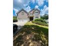 Charming two-story brick home with a well-manicured lawn and a two-car garage at 6398 Foggy Oak Dr, Fairburn, GA 30213