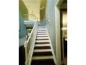 A classic staircase with white railings and dark treads leads to the upper level at 6398 Foggy Oak Dr, Fairburn, GA 30213