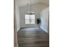 Dining room with new vinyl floors, wainscotting, a chandelier, and fresh paint at 1570 Jami Hollow Way, Lawrenceville, GA 30043