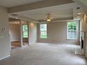 Spacious living room with neutral carpet, fireplace, decorative ceiling, and bright windows at 3457 Dacite Ct, South Fulton, GA 30349