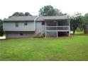 A view of the back of the house and yard, including a deck with railing and stairs to the ground at 4187 Alaina Cir, Austell, GA 30106
