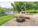 Backyard with a fire pit, green grass, and a basketball hoop, perfect for outdoor gatherings at 8035 Rockbridge Rd, Lithonia, GA 30058