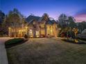A luxurious home with impressive stone facade and meticulously maintained lawn at 1310 Settles Rd, Suwanee, GA 30024