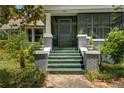 Inviting front entrance with green steps, brick accents, and a charming screen door at 222 Winonna Dr, Decatur, GA 30030