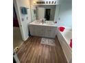 Bathroom featuring double sinks, modern vanity with storage, and a large mirror at 355 Tambec Nw Trce, Lilburn, GA 30047