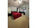 Large bedroom with ceiling fan, spacious layout with room for a desk, and neutral carpet at 355 Tambec Nw Trce, Lilburn, GA 30047