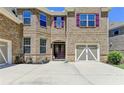 Attractive brick home featuring a two-car garage and neat landscaping at 4395 Wildbrooke Pkwy, Cumming, GA 30041