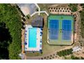 Aerial view of a community pool and tennis courts, surrounded by lush landscaping and convenient parking at 1264 Brynhill Ct, Buford, GA 30518