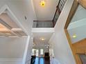 Bright, open foyer with soaring ceilings and decorative staircase railing detail at 1264 Brynhill Ct, Buford, GA 30518