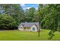Picturesque single-Gathering home nestled among mature trees, boasting a well-kept lawn and welcoming facade at 4030 Grady Smith Road Rd, Loganville, GA 30052