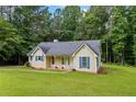 Traditional single-Gathering home with a spacious front yard, showcasing a classic design and serene setting at 4030 Grady Smith Road Rd, Loganville, GA 30052