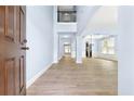 Bright foyer with hardwood floors, high ceilings, and views into the living spaces at 5430 Breckinridge Ln, Cumming, GA 30040