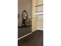 Hallway leading to a loft with decoratively appointed mirror and table at 188 Rue Fontaine, Lithonia, GA 30038