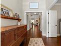Hallway with dark wood floors, light walls, with decoratively adorned console table at 5015 Monticello Dr, Villa Rica, GA 30180