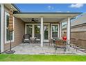 Relaxing covered patio with ceiling fan, outdoor seating, and a view of the yard at 205 Floral Valley Dr, Woodstock, GA 30188