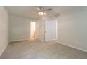 Spacious bedroom features a ceiling fan and neutral carpet, with multiple closets and access to an ensuite bathroom at 356 Waterway Trl, Powder Springs, GA 30127