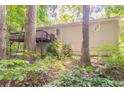 The rear of the home features a large wooden deck and is surrounded by lush foliage at 356 Waterway Trl, Powder Springs, GA 30127