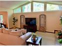 Bright living room with large windows, neutral decor and cozy seating arrangement at 1260 Willeo Creek Dr, Roswell, GA 30075