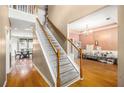 Inviting foyer with hardwood floors, staircase, and views into the dining and living areas at 485 Greyhawk Way, Fairburn, GA 30213