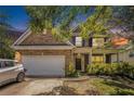 Charming two-story brick home featuring a two-car garage and a welcoming front porch at sunset at 485 Greyhawk Way, Fairburn, GA 30213