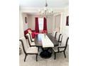 Elegant dining room featuring a chandelier, large table with seating for six, and neutral decor at 5625 Jamerson Dr, Atlanta, GA 30349