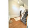 Bright foyer with hardwood floors, a staircase, and neutral wall paint offering a welcoming entrance at 5625 Jamerson Dr, Atlanta, GA 30349