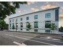 Exterior view of a three-story, white loft-style condo building with large windows and professional landscaping at 108 Park Pl # 108, Atlanta, GA 30030