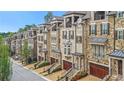 Charming stone and brick townhomes feature private garages and meticulous landscaping at 3450 Commander Cv, Suwanee, GA 30024