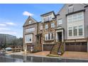 Attractive townhomes featuring stone and brickwork, private garages, and well-kept landscaping at 3450 Commander Cv, Suwanee, GA 30024