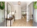 Elegant foyer with a decorative mirror, stylish lighting, and hardwood floors leading into the home at 4430 Alister Park Dr, Cumming, GA 30040
