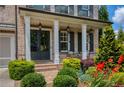 Inviting front entrance with a covered porch, well-maintained landscaping, and clear property number signage at 4430 Alister Park Dr, Cumming, GA 30040