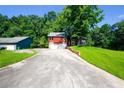 Charming home boasts a stone facade, two-car garage, and a well-maintained front yard, all nestled on a tree-lined lot at 1030 Chapman Ln, Stone Mountain, GA 30088