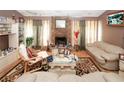 Comfortable living room featuring a stone fireplace, neutral decor, and ample natural light creating a relaxed ambiance at 1030 Chapman Ln, Stone Mountain, GA 30088