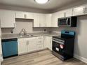 Modern kitchen features white cabinets, stainless steel appliances, and stylish granite countertops at 2764 Ocean Valley Dr, Atlanta, GA 30349