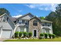 Charming two-story home featuring stone accents, a well-manicured lawn, and an attached two-car garage at 3939 Craggy Perch, Douglasville, GA 30135