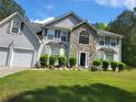 Charming two-story home featuring stone accents, a well-manicured lawn, and an attached two-car garage at 3939 Craggy Perch, Douglasville, GA 30135