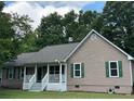 Exterior view of a home with white columns, a covered porch, and green shutters at 10 Vaughan Ne Ct, Cartersville, GA 30121