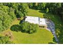 Aerial view features a modern home surrounded by trees and green lawn at 110 Bridger Point Rd, Fayetteville, GA 30215