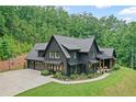 Beautiful new construction home boasts a three car garage, basketball court and front porch at 2100 Mountain Cove Ct, Woodstock, GA 30188