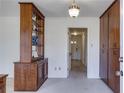 Neutral hallway with decorative light fixture and storage cabinets at 6339 Cornelia Dr, Douglasville, GA 30134