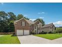 Beautiful brick home boasts a well-maintained lawn, two-car garage, and inviting exterior at 775 Gran Heritage Way, Dacula, GA 30019