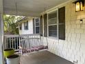 Close up of porch with swing, siding, windows, and a light fixture at 1003 Valley Se Dr, Smyrna, GA 30080