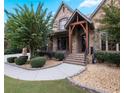 Beautiful stone home with a covered entryway and landscaped yard at 1255 Mcminn Way, Snellville, GA 30078