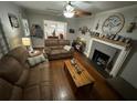 Inviting living room features hardwood floors, neutral paint and a fireplace with decorative mantle at 2591 Perkerson Dr, Austell, GA 30168